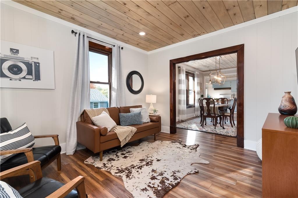a living room with furniture a couch and wooden floor