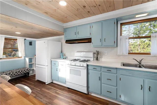 a kitchen with a stove a sink and a refrigerator