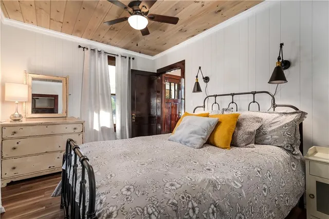 a bedroom with a bed and painting on the wall