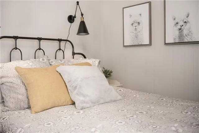 a bedroom with a large bed and a chandelier