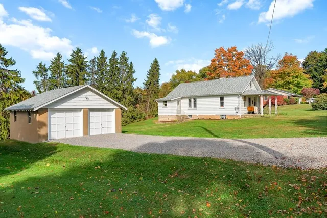 a house with green field in front of it