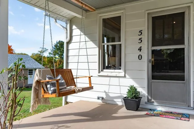 a view of a house with sitting area and garden