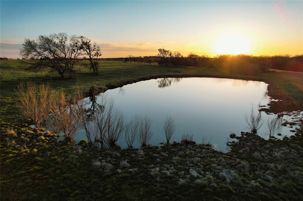 992 Bennett Road Howe, TX 75459 - Photo 2 of 26 a view of a lake in middle of forest