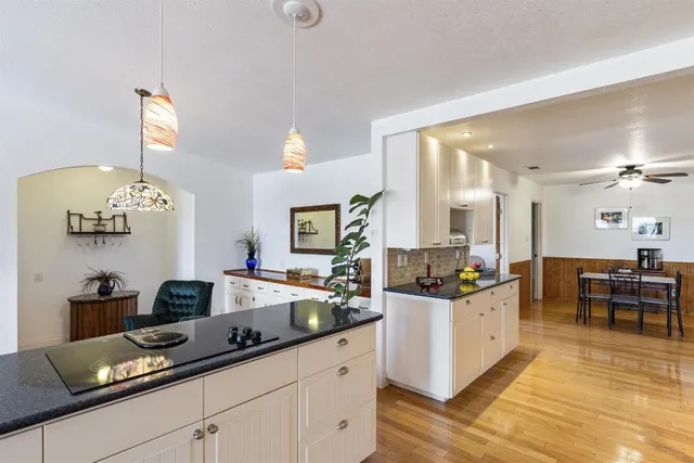 a living room with kitchen island furniture and a chandelier