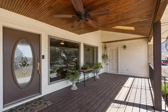 a view of a hallway with entryway wooden floor and front door