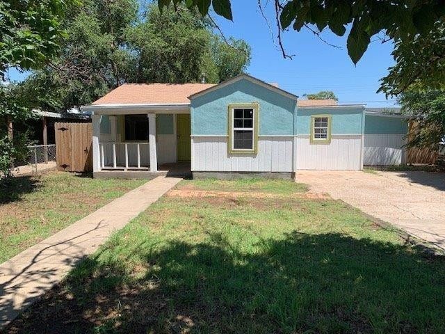 3014 Duke Street Lubbock, TX 79415 - Photo 2 of 10 a front view of a house with a garden and yard