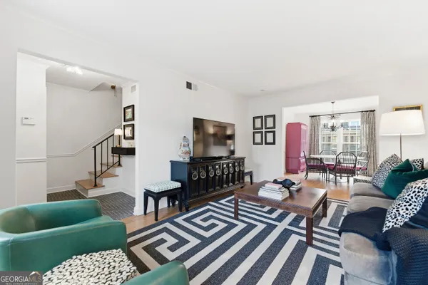 a living room with furniture and a rug