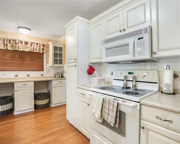 a kitchen with stainless steel appliances granite countertop a sink and cabinets