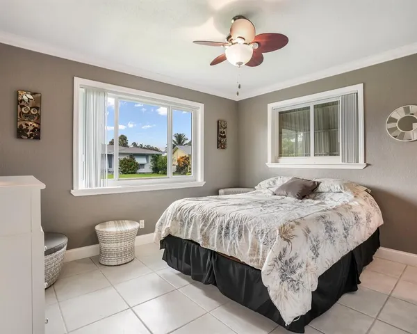 a bedroom with a large bed and a window