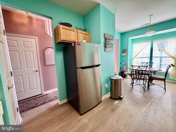 a living room with furniture a flat screen tv and a large window