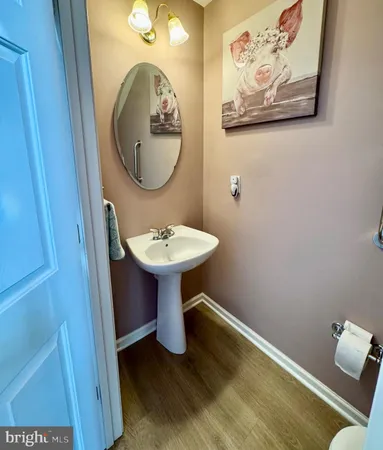 a living room with furniture a piano and a bookshelf