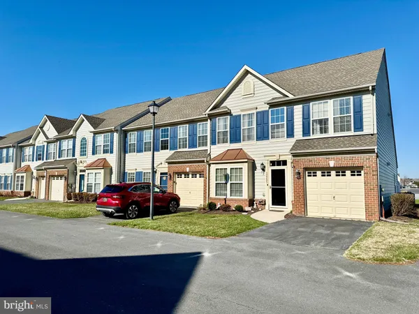 a kitchen with stainless steel appliances kitchen island granite countertop a refrigerator stove top oven with a sink and dishwasher