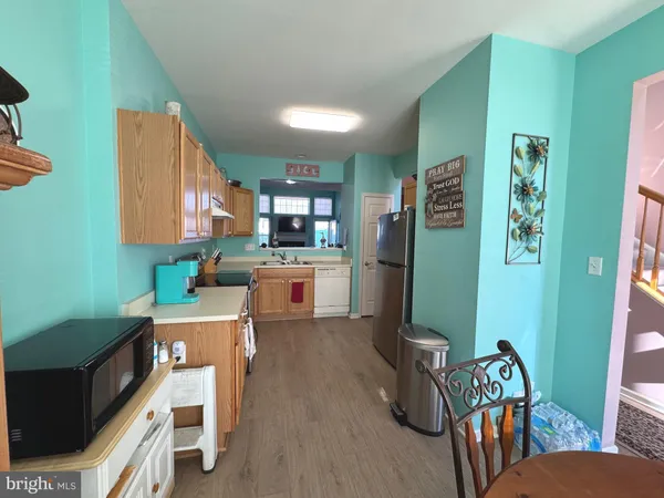 a kitchen with stainless steel appliances a stove a sink a refrigerator and cabinets