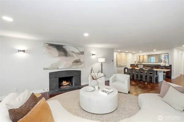 a kitchen with granite countertop a table chairs sink and wooden floor