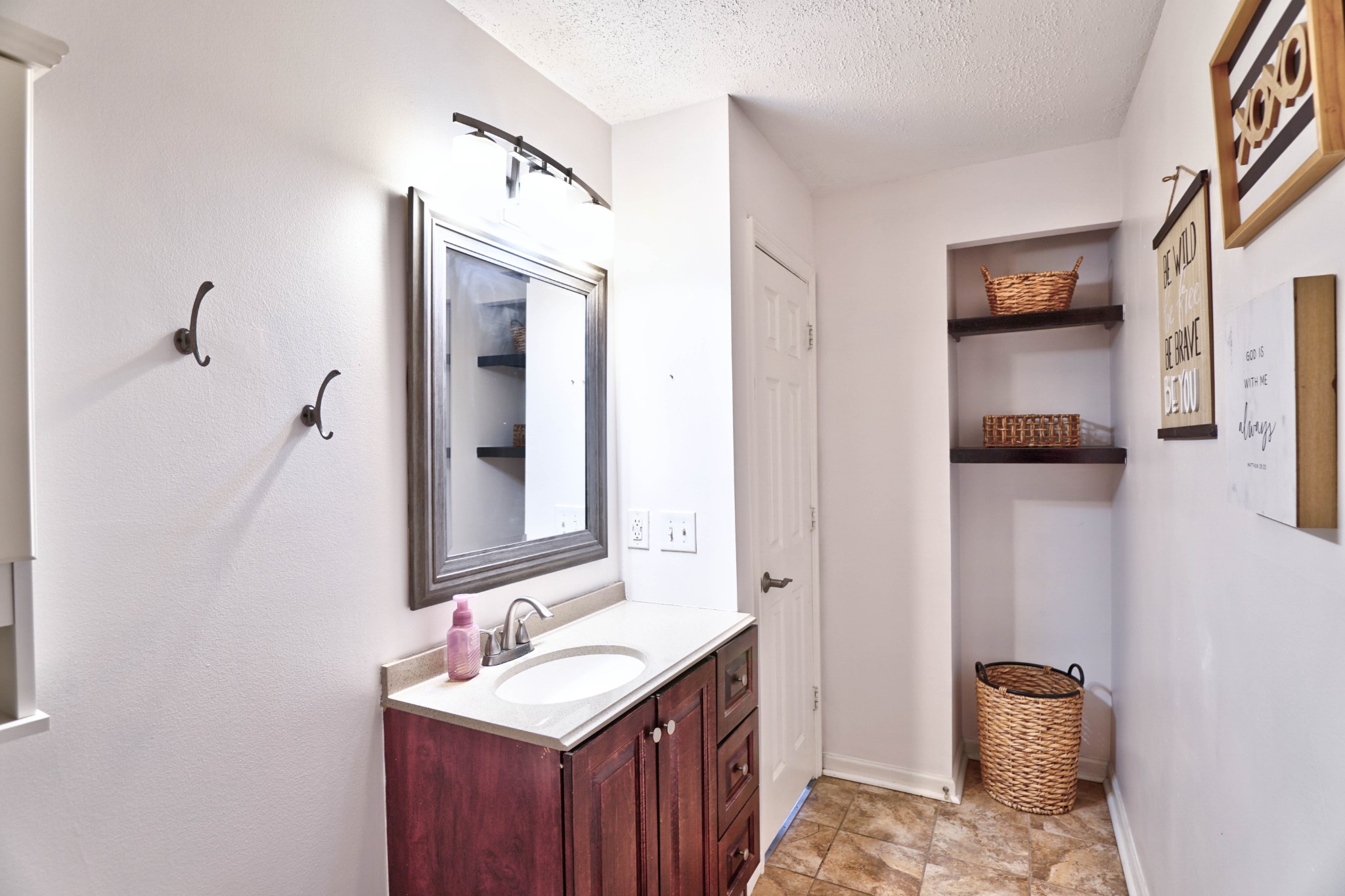 5871 Cane Ridge Road Antioch, TN 37013 - Photo 33 of 40 a bathroom with a sink a mirror and vanity