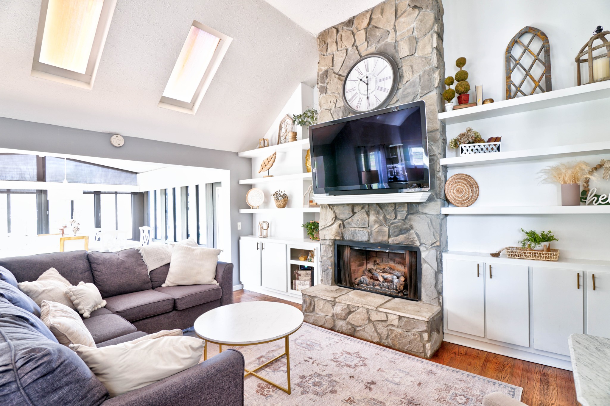 5871 Cane Ridge Road Antioch, TN 37013 - Photo 6 of 40 a living room with furniture a fireplace and a flat screen tv