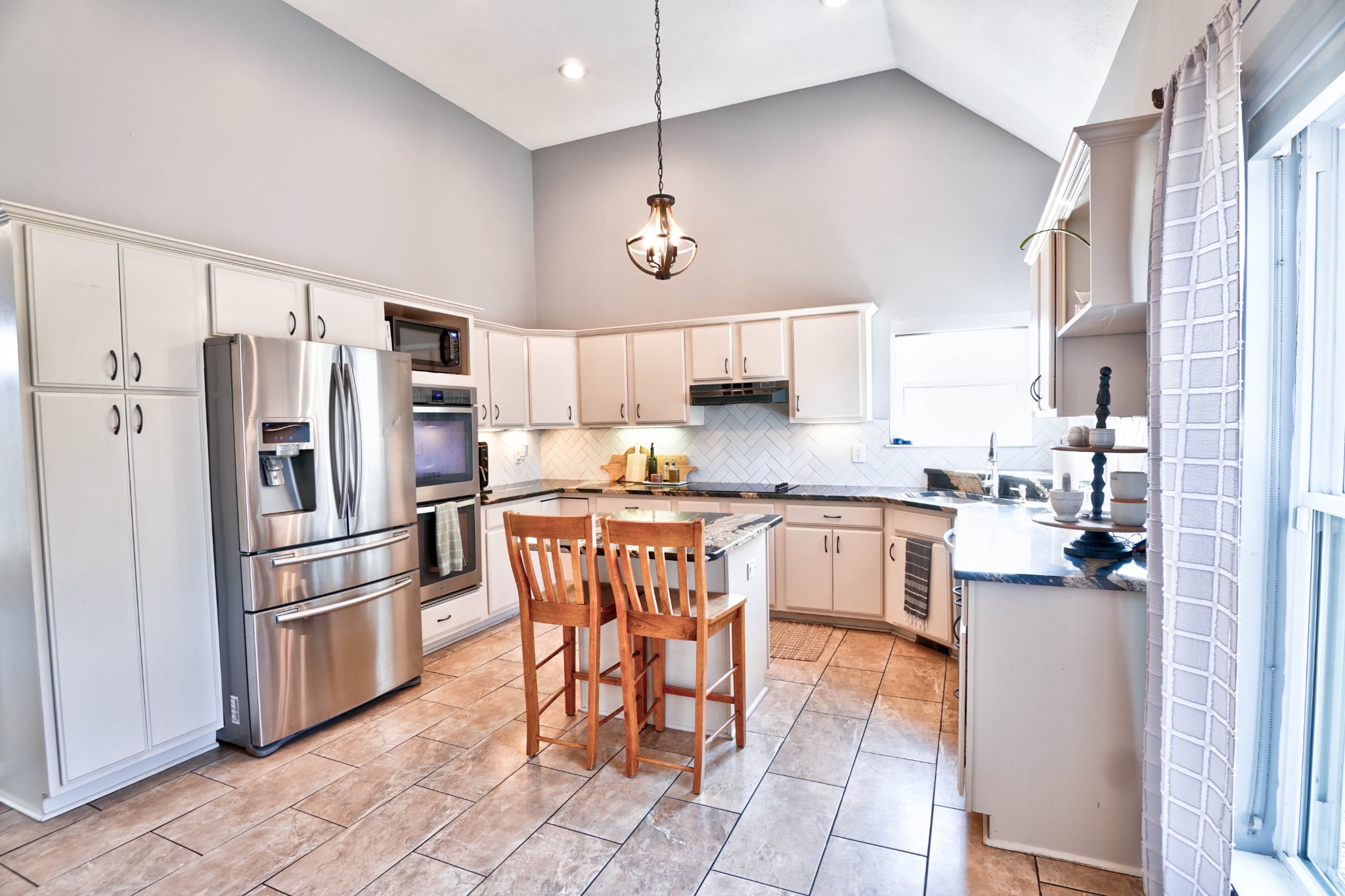 5871 Cane Ridge Road Antioch, TN 37013 - Photo 9 of 40 a kitchen with stainless steel appliances granite countertop a refrigerator a sink a stove a dining table and chairs
