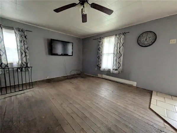wooden floor in an empty room with a window