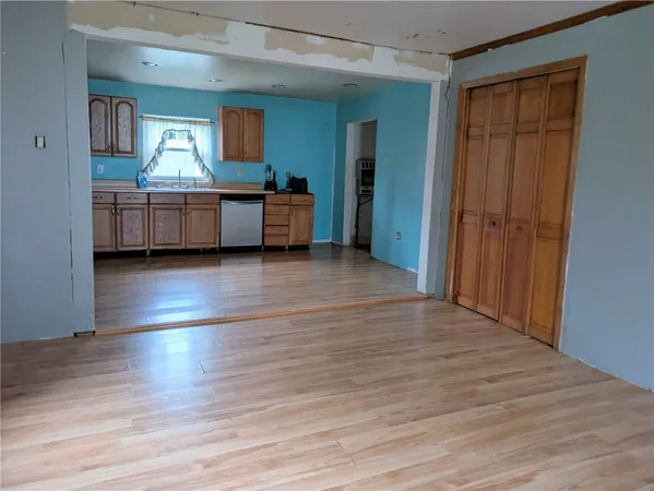 a view of a room with wooden floor and cabinet