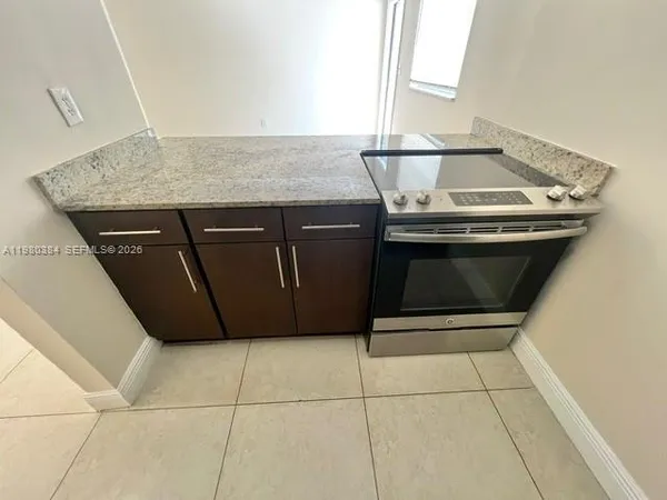 a stove top oven sitting inside of a kitchen