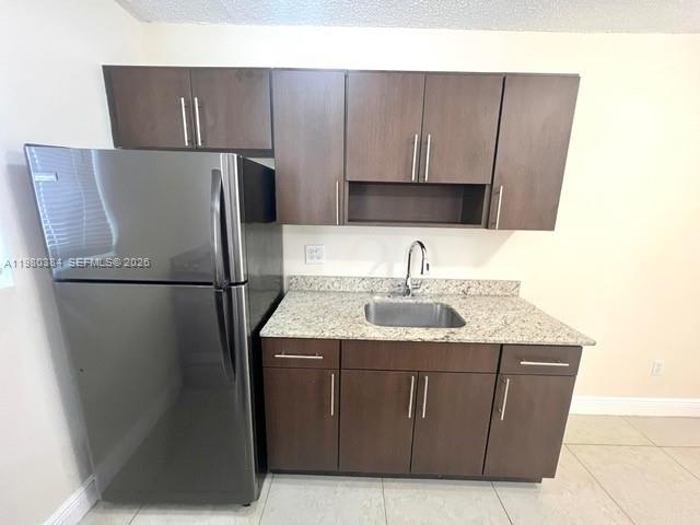 685 Northeast 85th Street, Unit 8 Miami, FL 33138 - Photo 2 of 6 a kitchen with a sink a refrigerator freezer a washer and dryer