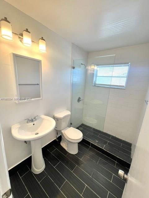 685 Northeast 85th Street, Unit 8 Miami, FL 33138 - Photo 6 of 6 a bathroom with a sink toilet and mirror