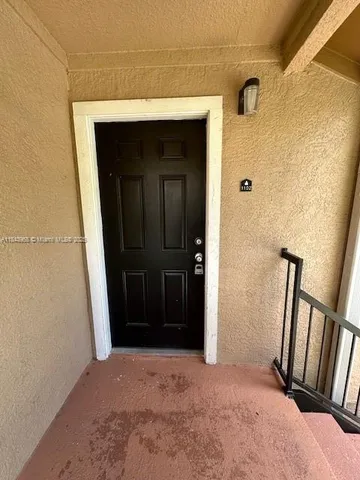 a view of hallway with wooden floor and stairs
