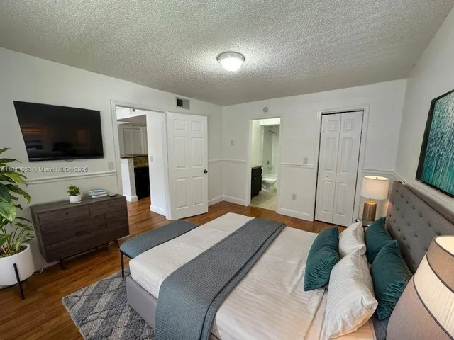 a bedroom with a bed and a television