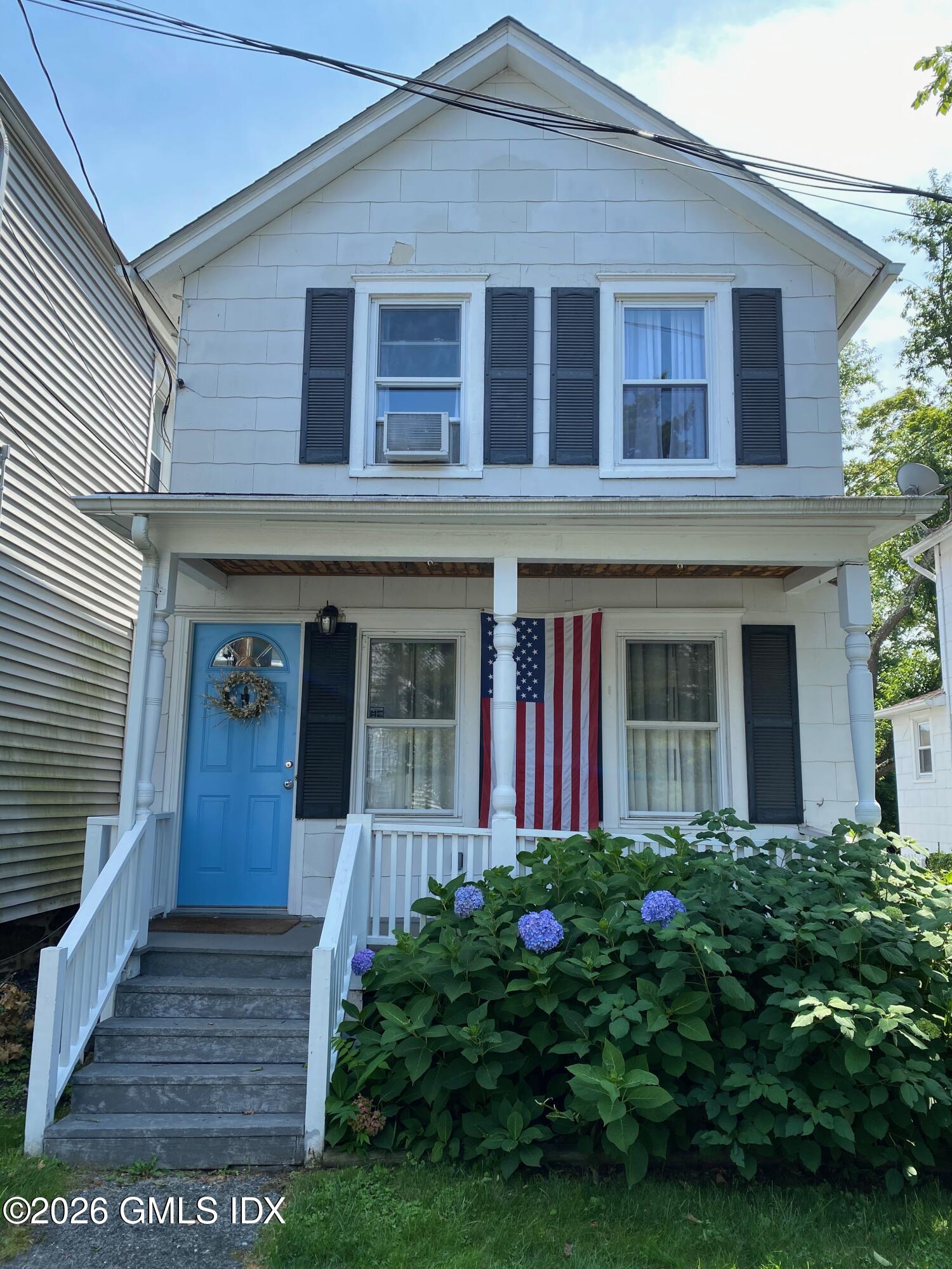 22 Division Street Greenwich, CT 06830 - Photo 1 of 29 a view of a house with potted plants and a yard