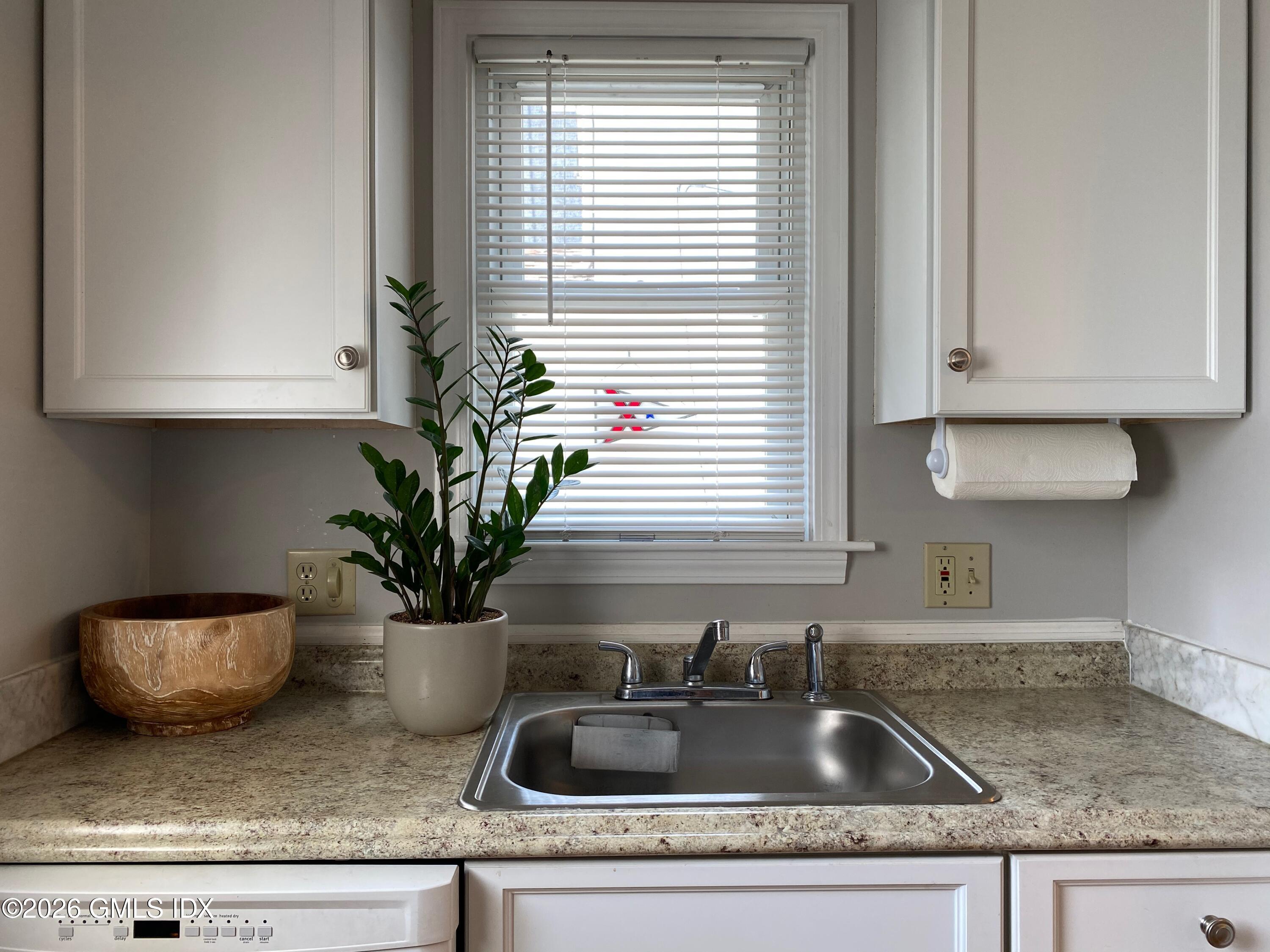 22 Division Street Greenwich, CT 06830 - Photo 13 of 29 a kitchen with a sink a potted plant and a window