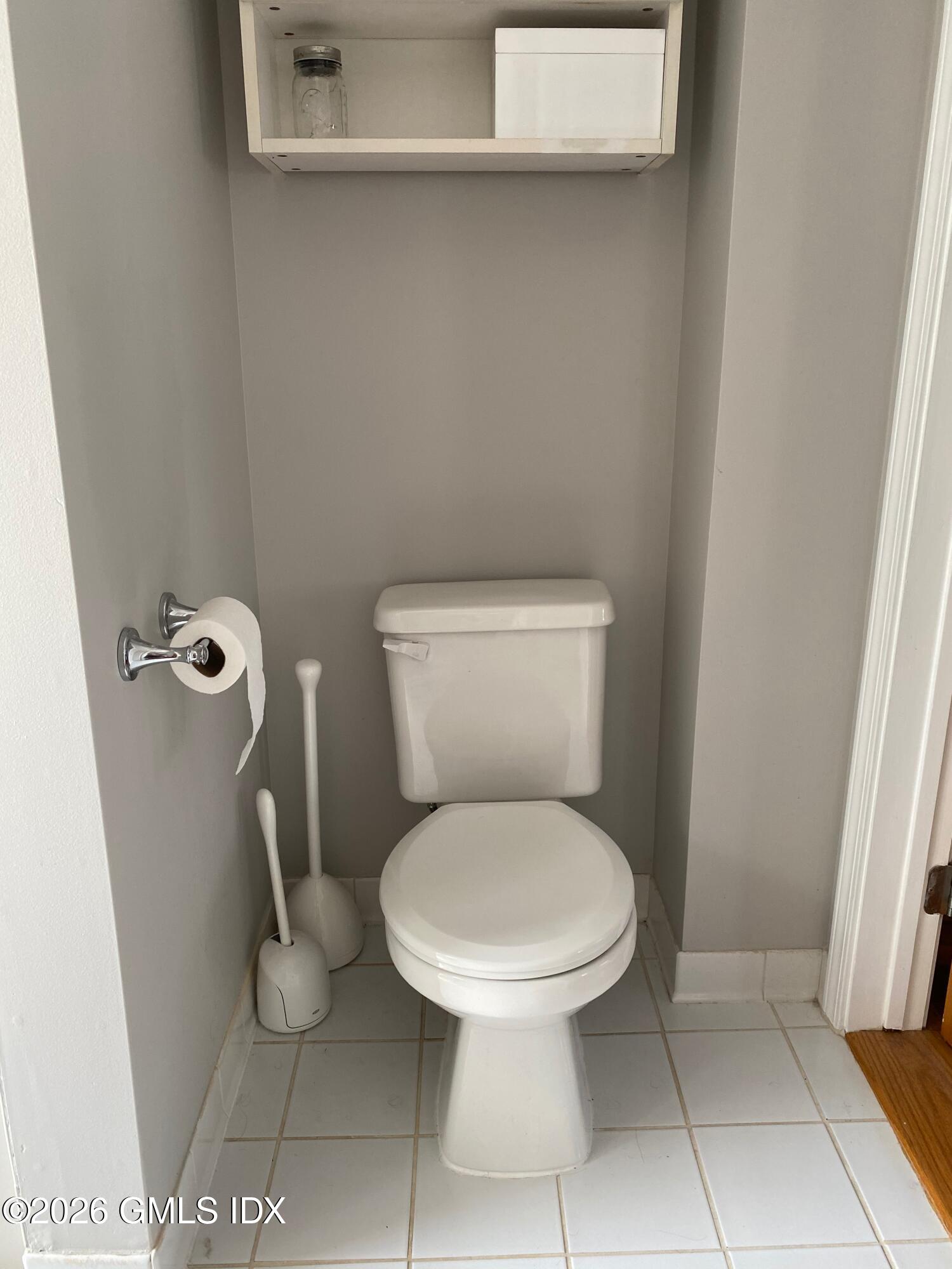 22 Division Street Greenwich, CT 06830 - Photo 24 of 29 a white toilet sitting next to a shower