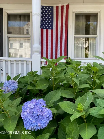 a view of a backyard of a house with a flower garden
