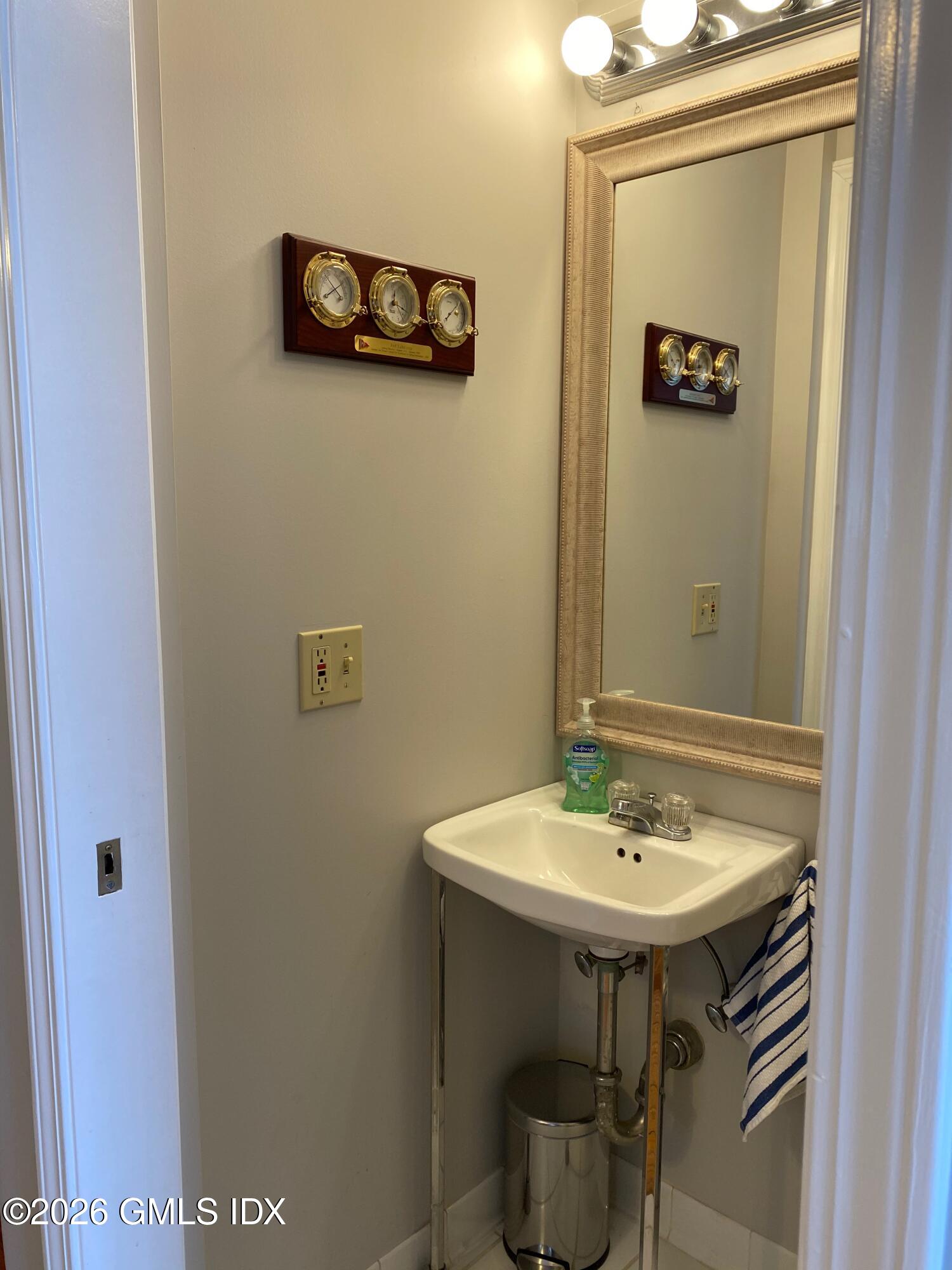 22 Division Street Greenwich, CT 06830 - Photo 9 of 29 a bathroom with a sink and a mirror