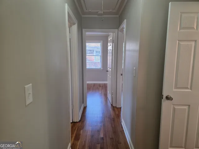 a view of a hallway with wooden floor