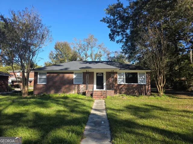 a front view of house with yard outdoor seating and green space