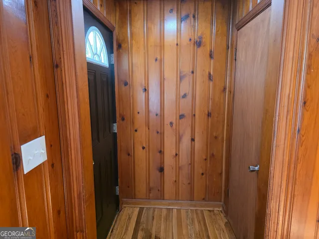 a view of a hallway with wooden floor