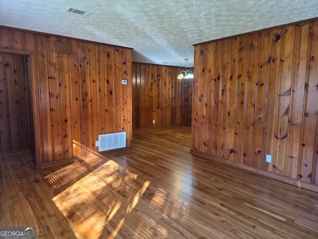 a view of a room with wooden walls