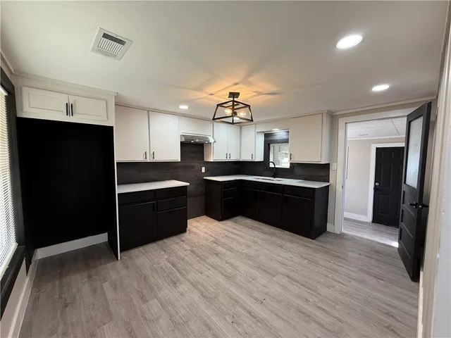 a kitchen with a sink and cabinets