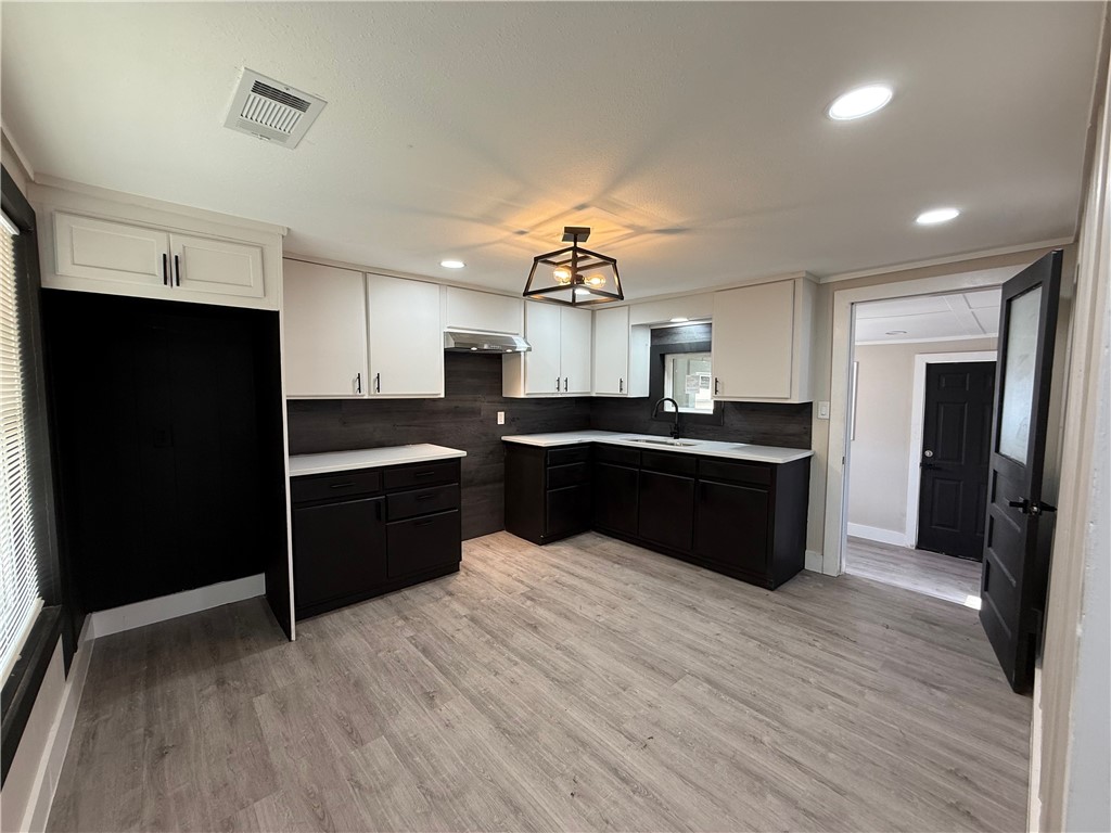 a kitchen with a sink and cabinets