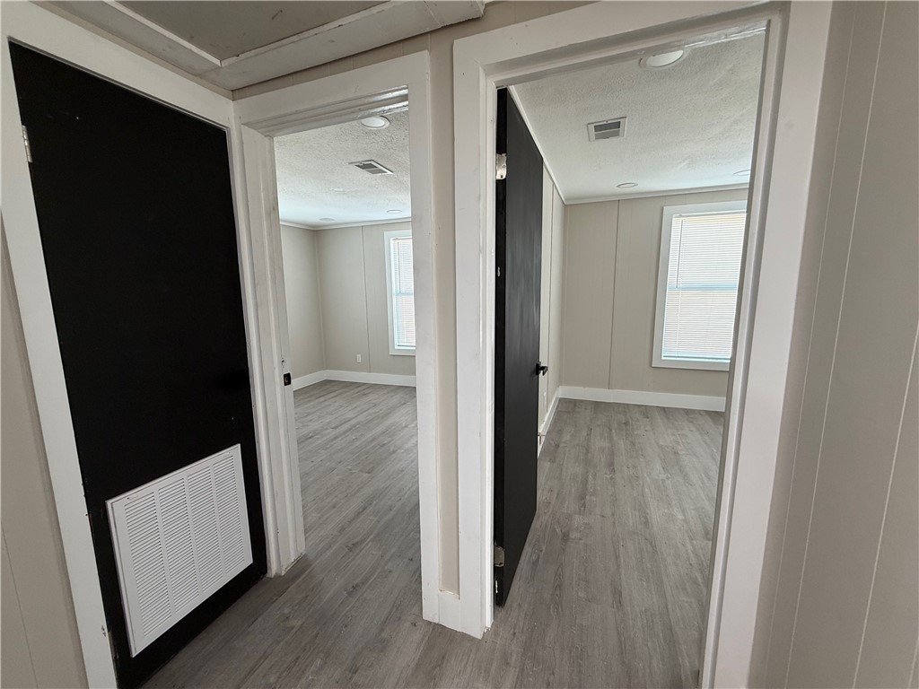 400 Austin Street George West, TX 78022 - Photo 19 of 23 a view of a hallway with wooden floor