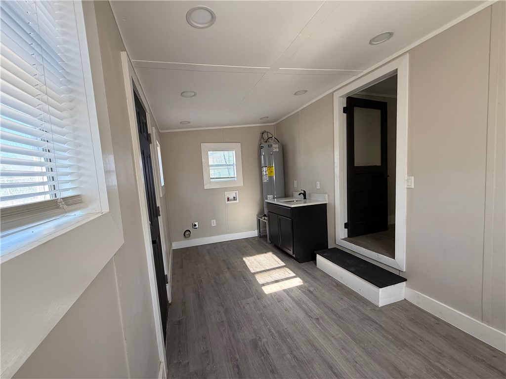 400 Austin Street George West, TX 78022 - Photo 21 of 23 a view of an empty room with wooden floor and a window