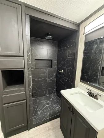 a bathroom with a sink toilet and shower