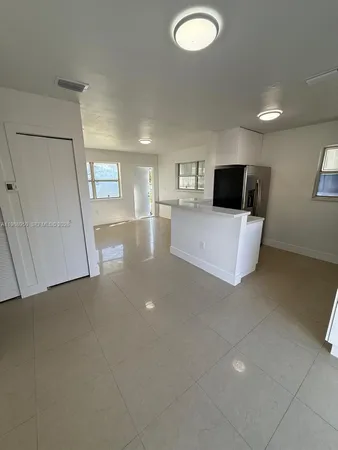 a view of a livingroom with furniture and a flat screen tv