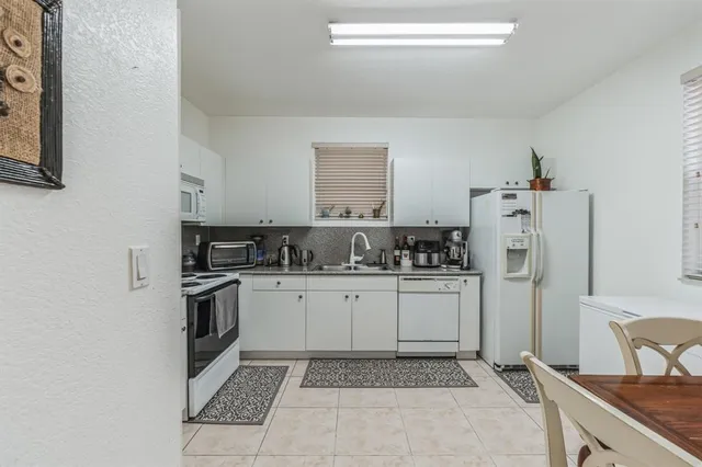 a kitchen with a sink cabinets and stainless steel appliances