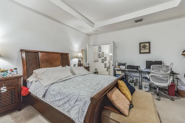 a bedroom with a bed and a table in it