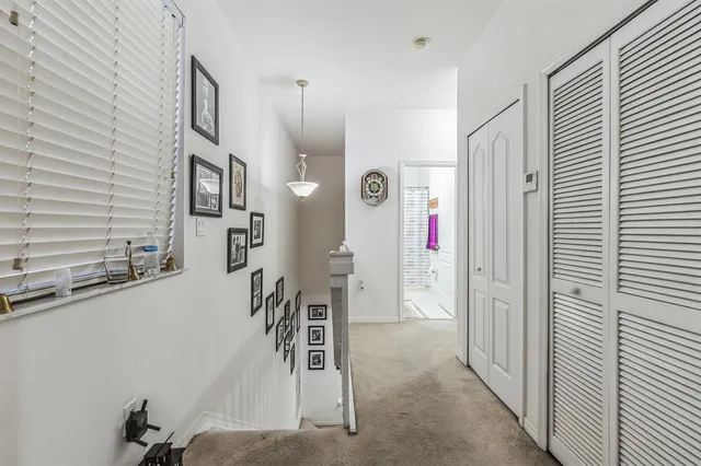 a view of a hallway with entryway door