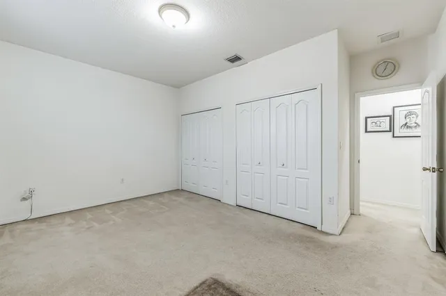 an empty room with a cabinet and mirror
