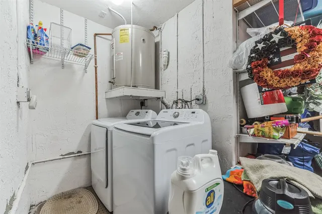 a utility room with a refrigerator and washer