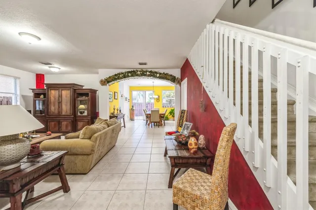 a living room with furniture and a potted plant