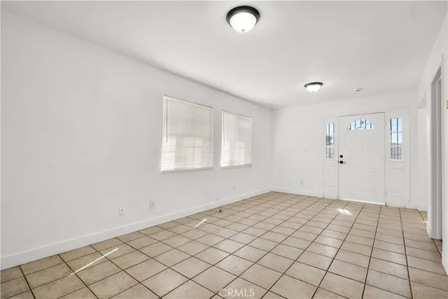 an empty room with white walls and tiles